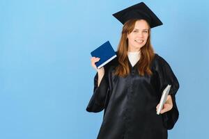 Beautiful woman wearing graduation cap and ceremony robe holding degree looking positive and happy standing and smiling with a confident smile. photo