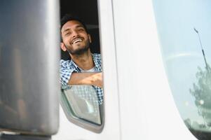 Young Indian truck driver. Concept of road freight transportation. photo