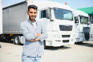 Young indian man standing in front of his truck. photo