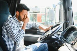 Exhausted truck driver falling asleep on steering wheel. Tiredness and sleeping concept photo