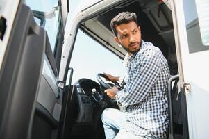 Young Indian truck driver. Concept of road freight transportation. photo