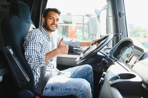 Happy professional truck driver driving his truck. Copy space. photo