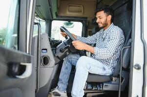 Happy professional truck driver driving his truck. Copy space. photo