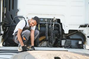 Man in uniform. Truck repair. Car malfunction photo