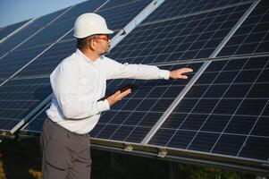 worker testing solar panels with tablet. photo