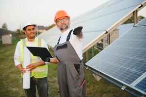 The solar farm with two engineers walk to check the operation of the system photo