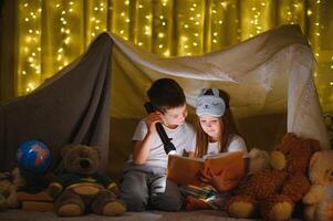 Little children reading bedtime story at home photo