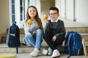 Happy school kids in corridor at school photo