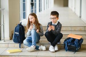 School kids in uniform together in corridor. Conception of education. photo