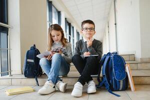 School kids with books together in corridor. Conception of education. photo