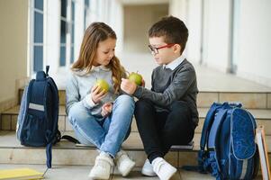 Happy school kids in corridor at school photo