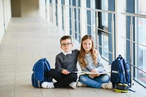 School kids in uniform together in corridor. Conception of education. photo