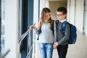 School kids in uniform together in corridor. Conception of education. photo