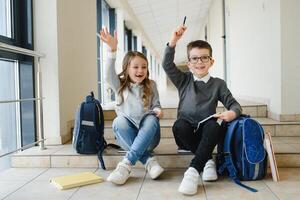 School kids with books together in corridor. Conception of education. photo