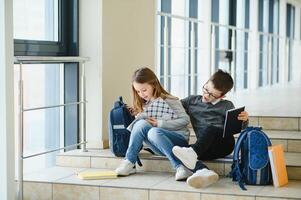 School kids with books together in corridor. Conception of education. photo