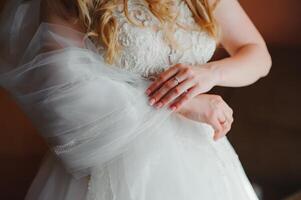 Bride dressing wedding gown. morning bride. photo