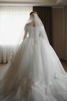 Bride dressing wedding gown. morning bride. photo