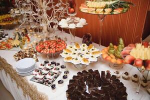 various dessert with fresh fruit on buffet line, sweet. photo