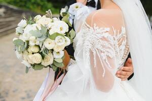 Bride holds a wedding bouquet, wedding dress, wedding details. photo