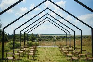 wonderful wedding ceremony. trendy wedding arch made according to modern fashion. wedding decorations photo