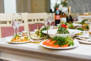 beautifully laid tables with glasses and appliances at morning in restaurant. photo