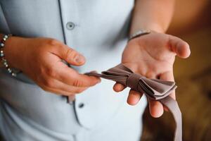 A man fastens buttons on his shirt photo