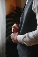 A man fastens buttons on his shirt photo