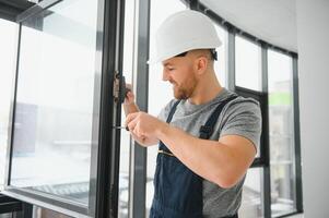 Professional master at repair and installation of windows, at work. photo