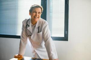 Portrait of senior female doctor in her office. photo