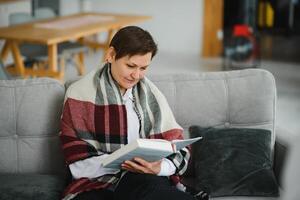 Senior woman reading book at home. photo