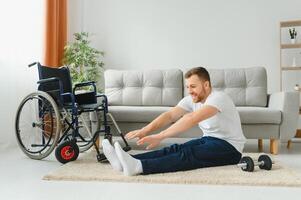 Disabled sportsman doing stretching and exercises on wheelchair background. Life of a disabled person. photo