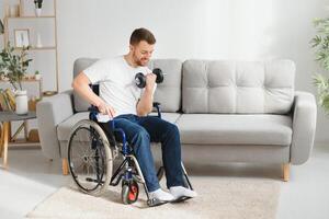 Man Disabled. Sports for Disabled. Male in Wheelchair with Dumbbells in Hands. Man with Dumbbells in Hands. Father Disabled Do Spotting. Sport at Apartment. Health Concept. Healthy Lifestyle photo