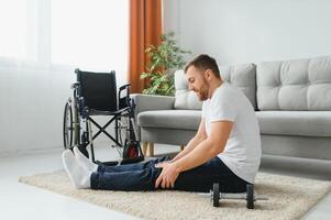 Disabled sportsman doing stretching and exercises on wheelchair background. Life of a disabled person. photo