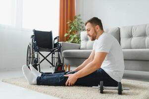 Disabled sportsman doing stretching and exercises on wheelchair background. Life of a disabled person photo