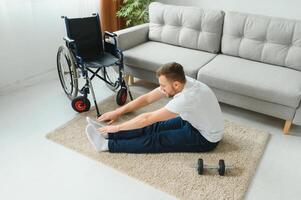 Disabled sportsman doing stretching and exercises on wheelchair background. Life of a disabled person. photo