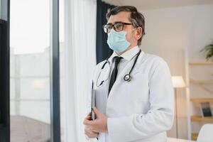 Close up of male doctor or scientist in protective facial mask. Medicine, healthcare and coronavirus pandemic concept photo