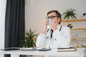 Close up of male doctor or scientist in protective facial mask. Medicine, healthcare and coronavirus pandemic concept photo