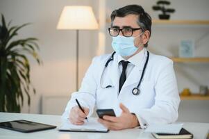 Close up of male doctor or scientist in protective facial mask. Medicine, healthcare and coronavirus pandemic concept photo