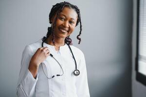 Portrait Of Smiling Female Doctor Wearing White Coat With Stethoscope In Hospital Office. photo