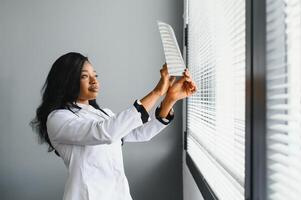 healthcare, medical and radiology concept - african doctor looking at x-rays. photo