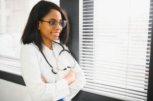 Portrait Of Smiling Female Doctor Wearing White Coat With Stethoscope In Hospital Office. photo