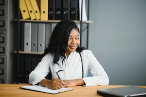 African female doctor make online telemedicine call consult patient. Afro american black woman therapist talking to camera in remote conference chat. Webcam view, face headshot. photo