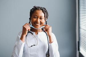 African female doctor in protective facial mask photo