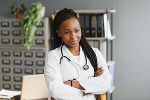 Portrait Of Female Doctor Wearing White Coat In Office. photo