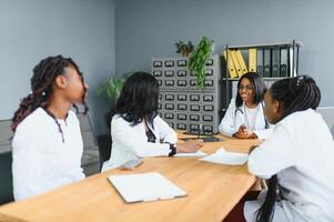 Medical Team Discussing Treatment Options With Patients. photo