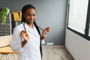 Portrait Of Female Doctor Wearing White Coat In Office. photo