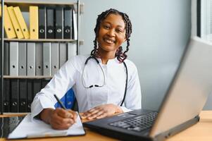 African female doctor make online telemedicine call consult patient. Afro american black woman therapist talking to camera in remote conference chat. Webcam view, face headshot. photo