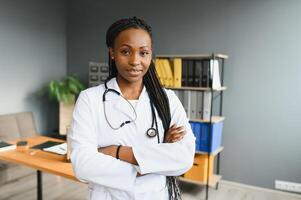 Portrait Of Smiling Female Doctor Wearing White Coat With Stethoscope In Hospital Office. photo