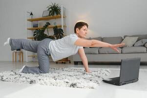 Middle age woman smiling happy doing exercise and stretching at home photo