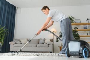 Cleaning concept. woman cleaning carpet with vacuum cleaner. photo